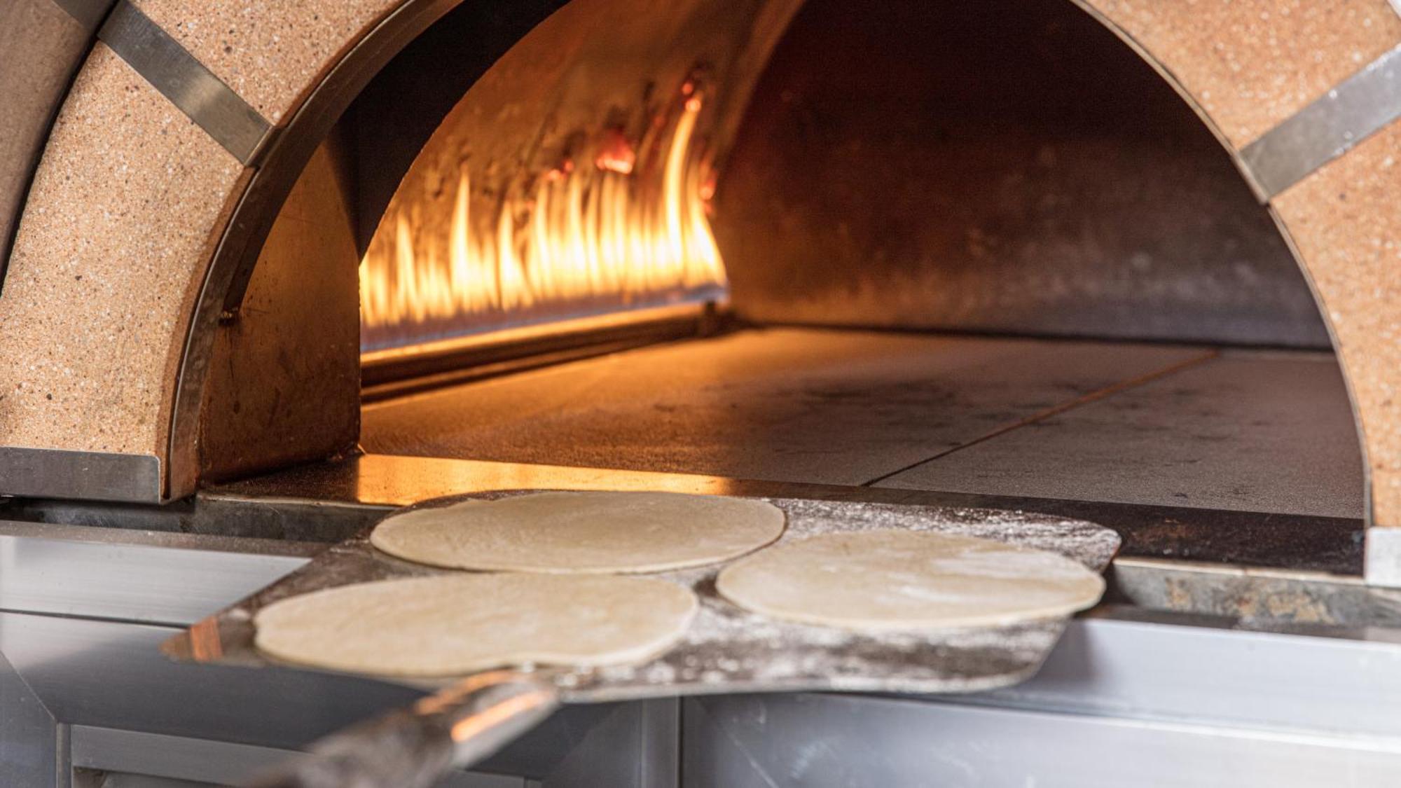 The Abdali Boulevard Hotel Amman Dış mekan fotoğraf Pizza dough in a wood-fired oven